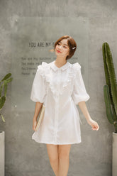 Silk dress with ruffled bib detail and puff sleeves in a structured A-line silhouette